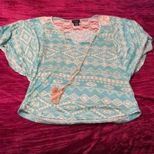 Teal short sleeved top with white Aztec print.